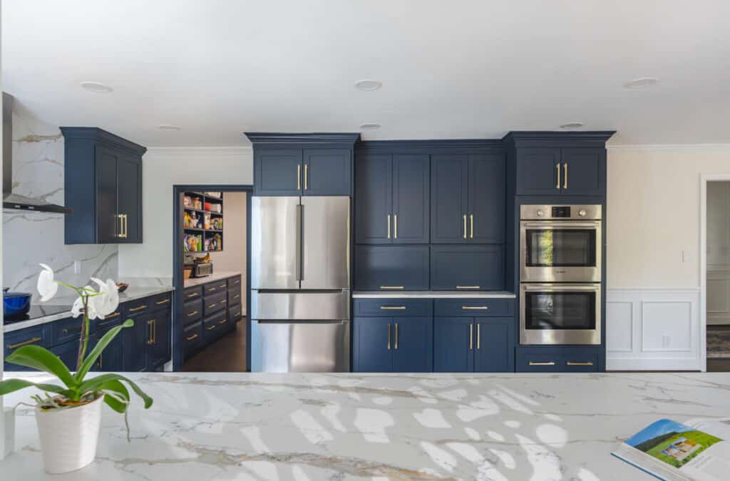 Blue cabinets and stainless steel appliances in a modern kitchen