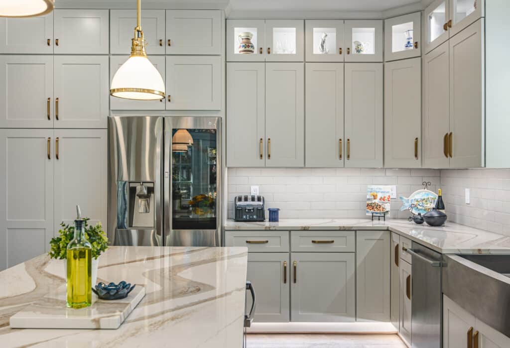 Kitchen featuring white cabinets and gold accents
